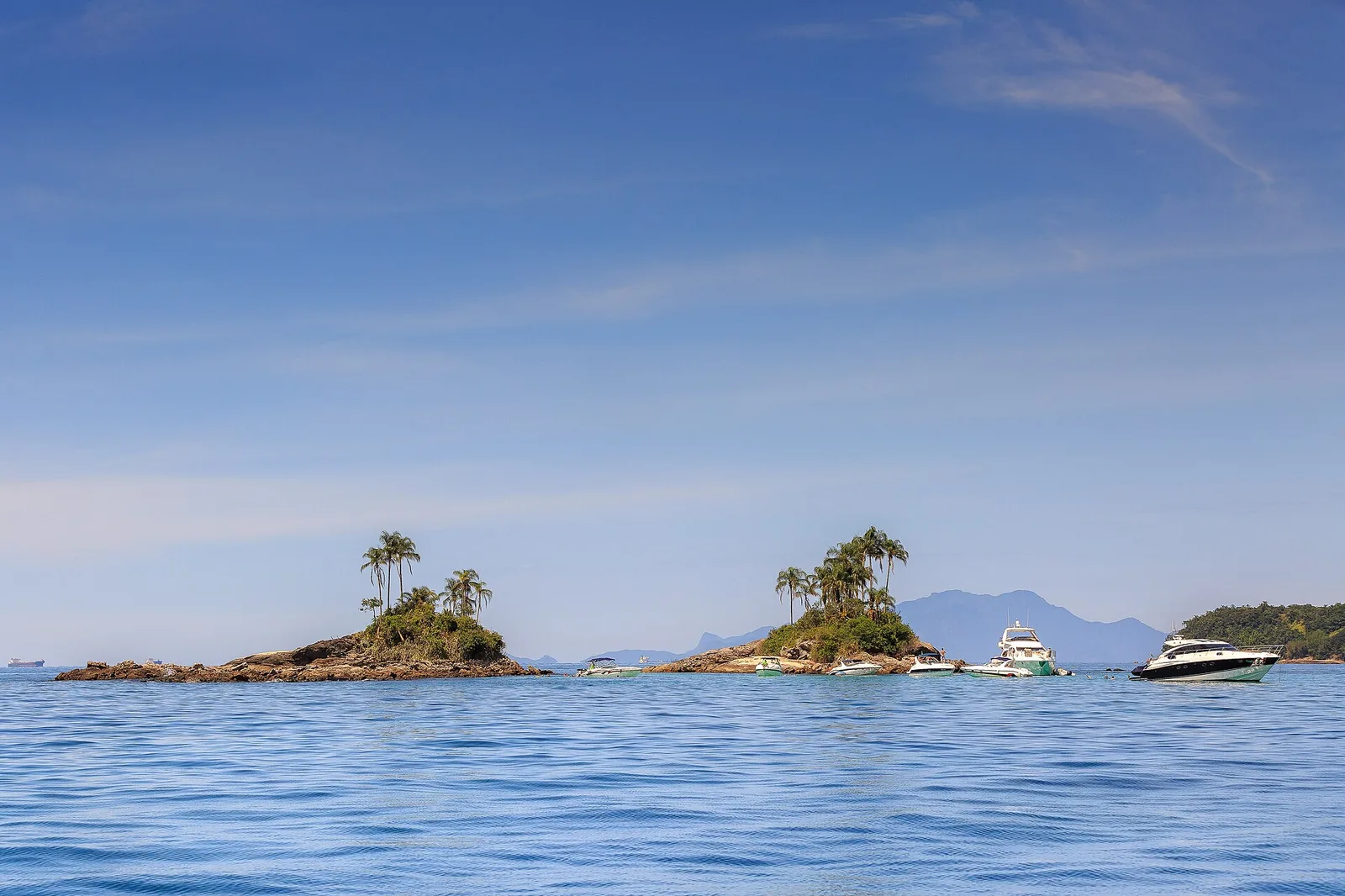 Ilha das Botinas in the Angra archipelago, where the green hills meet unusually clear water.
