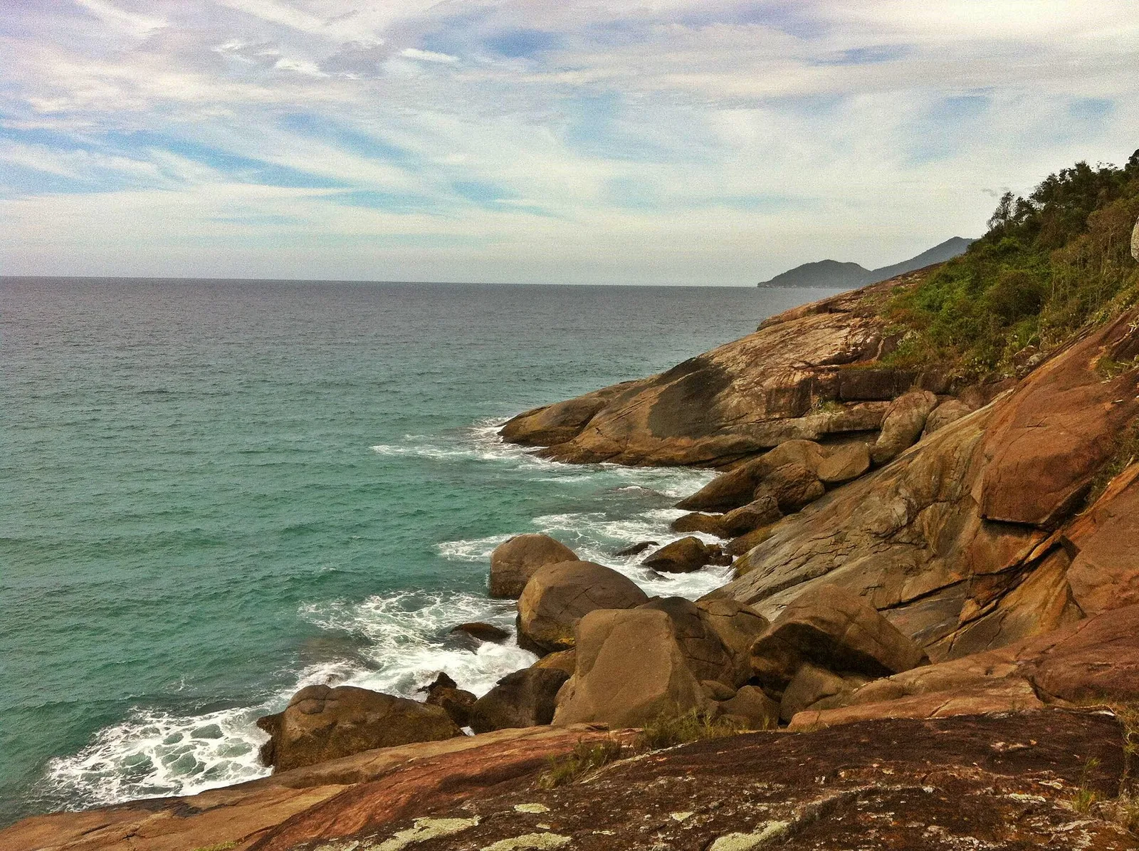 Green water and granite: the island's coastline is almost entirely undeveloped.