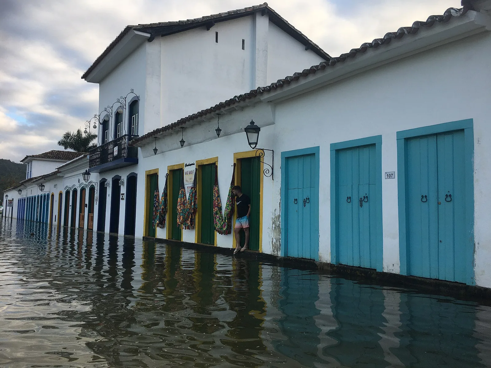 Lime-washed walls and coloured window frames — the restrained palette that gives Paraty its calm.