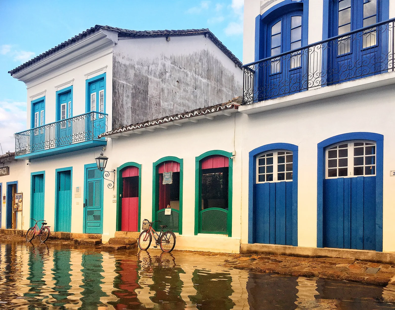 A street in Paraty's historic centre, laid in the irregular pé-de-moleque cobbles that flood at the spring tides.