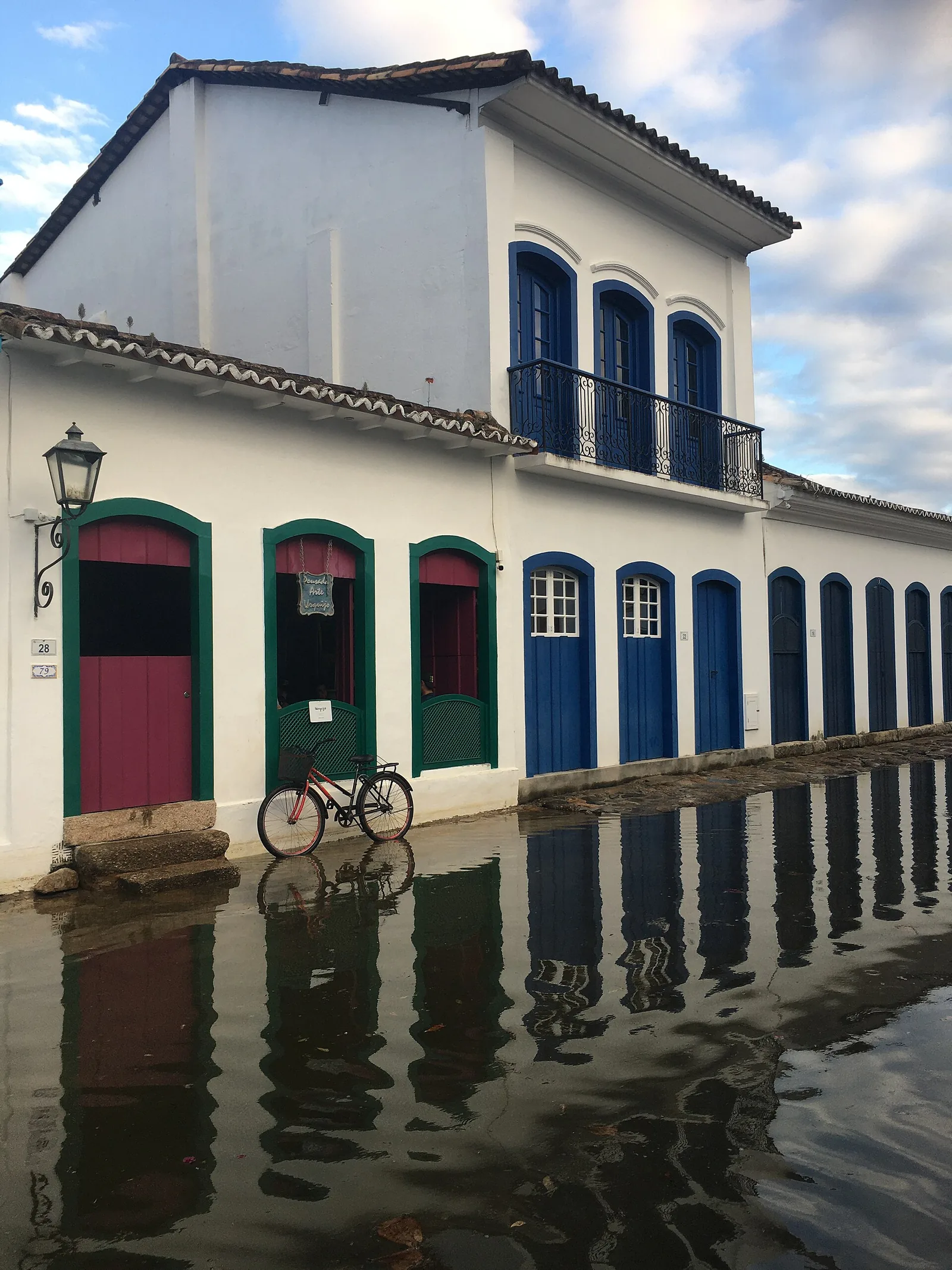 Lime-washed walls and coloured window frames in the historic centre, the restrained grammar of a merchant town.