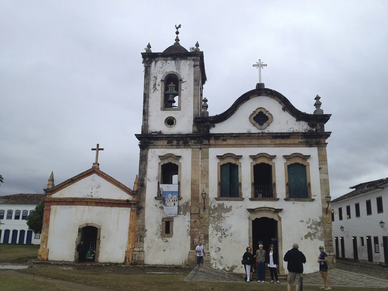 Inside a Paraty church: a carved and gilded side altar, the kind of quiet baroque work that rewards a slow look.