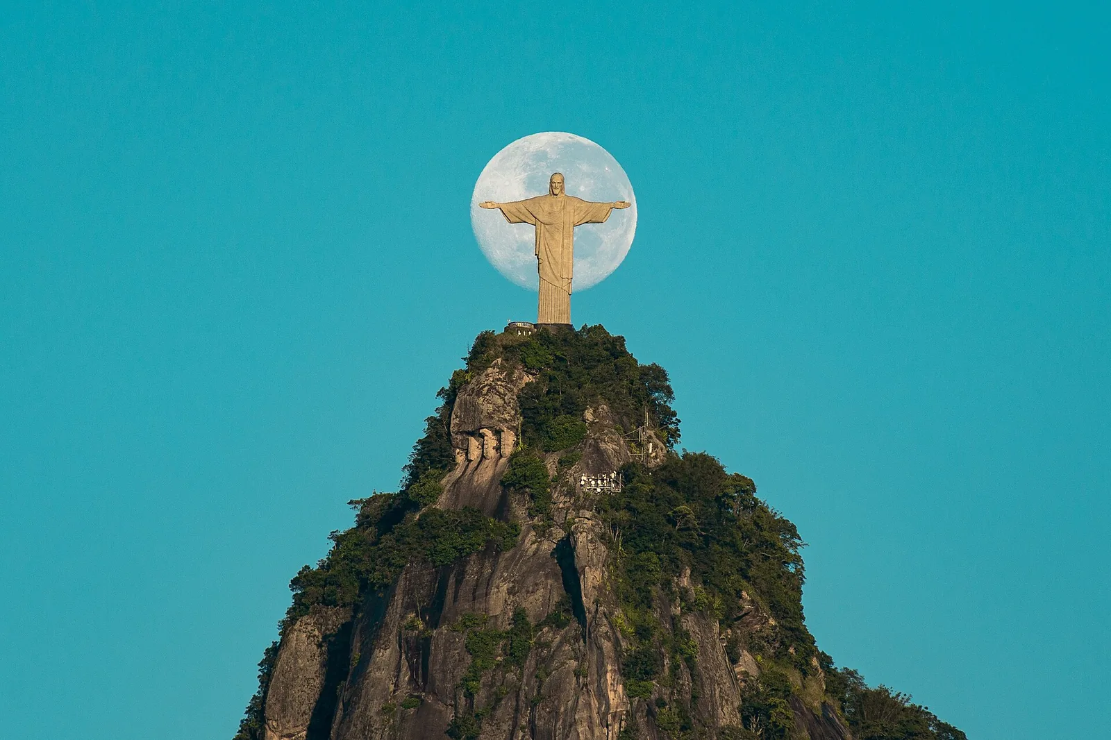 The moon rising behind the statue — Rio at its most theatrical, and worth lingering for.